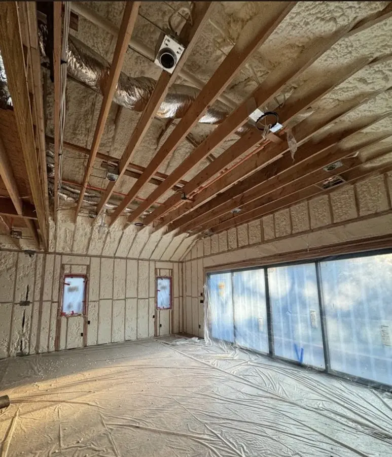 Interior walls and ceiling insulated with spray foam during new construction in Williamsburg